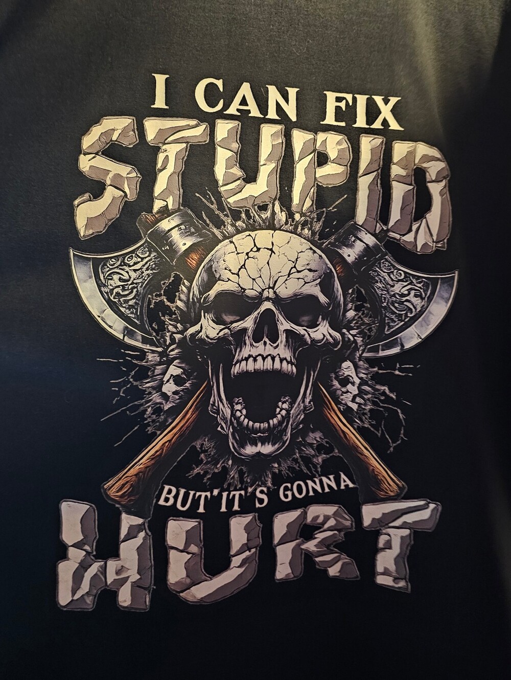 This is a graphic t-shirt featuring a skull and axe design